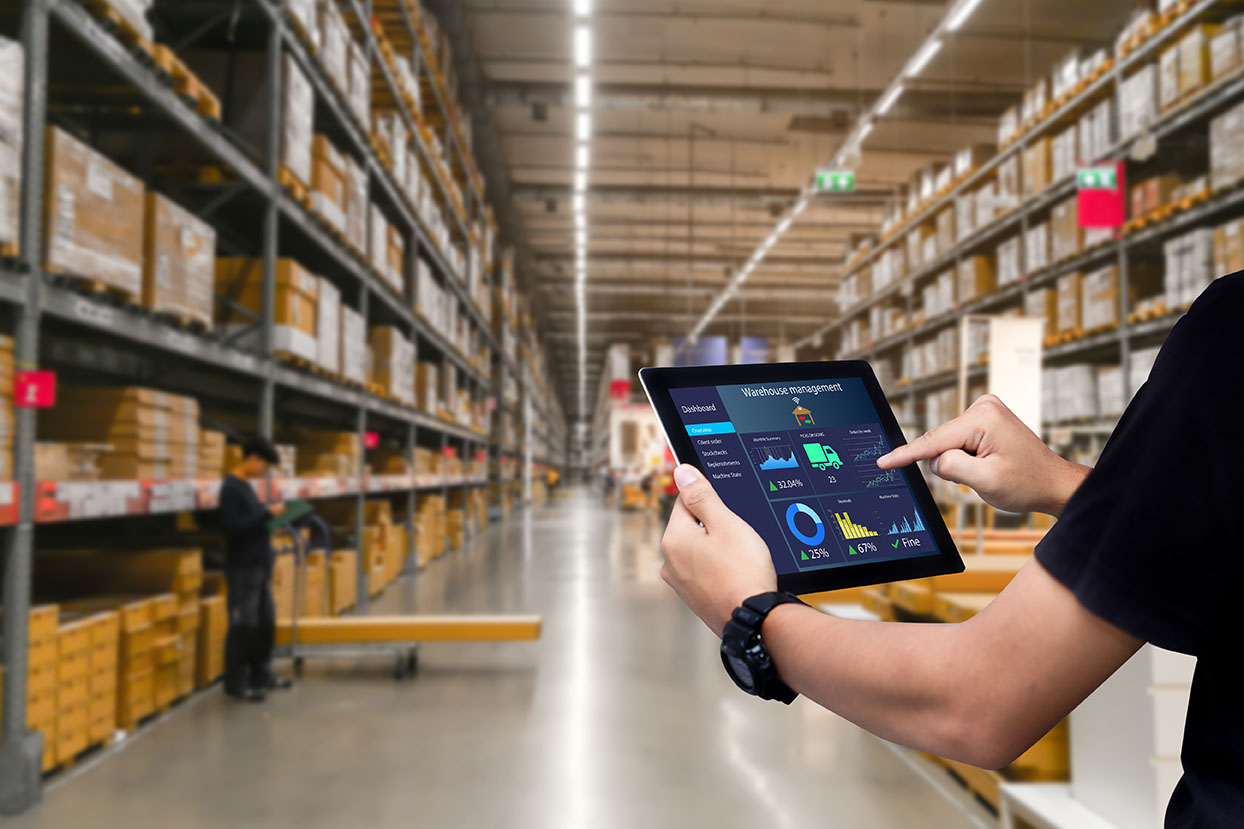 Smart warehouse management system.Worker hands holding tablet on